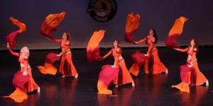 Belly dance troupe costumes in firey orange and maroon 